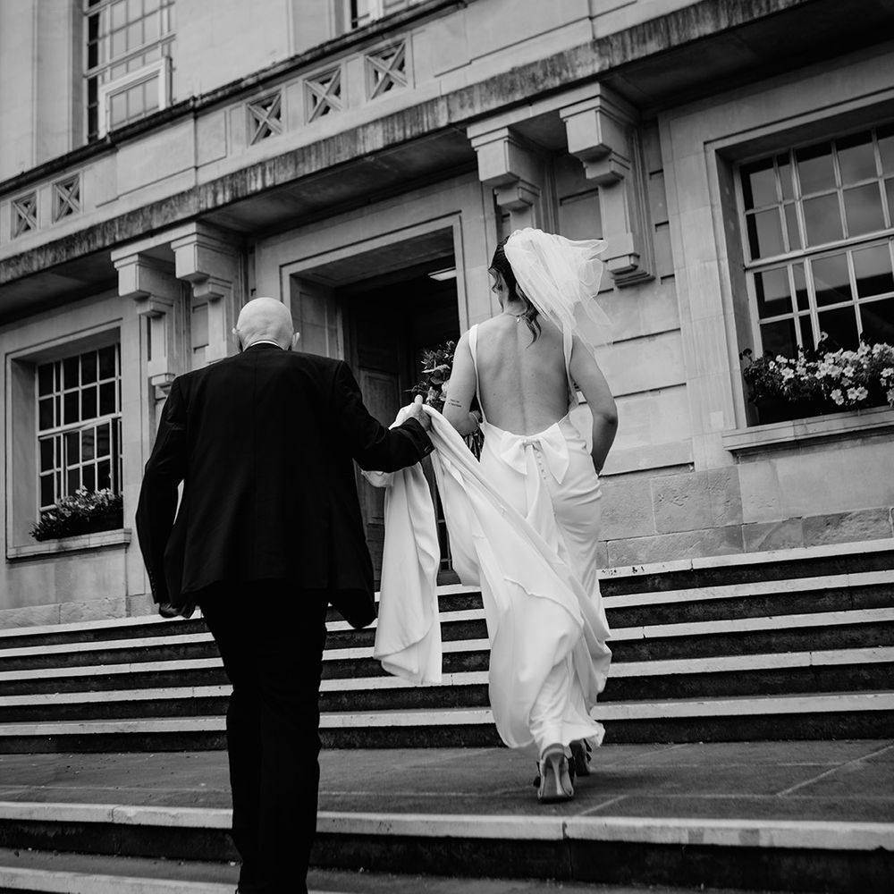 father-of-the-bride-walks-bride-into-town-hall-wedding