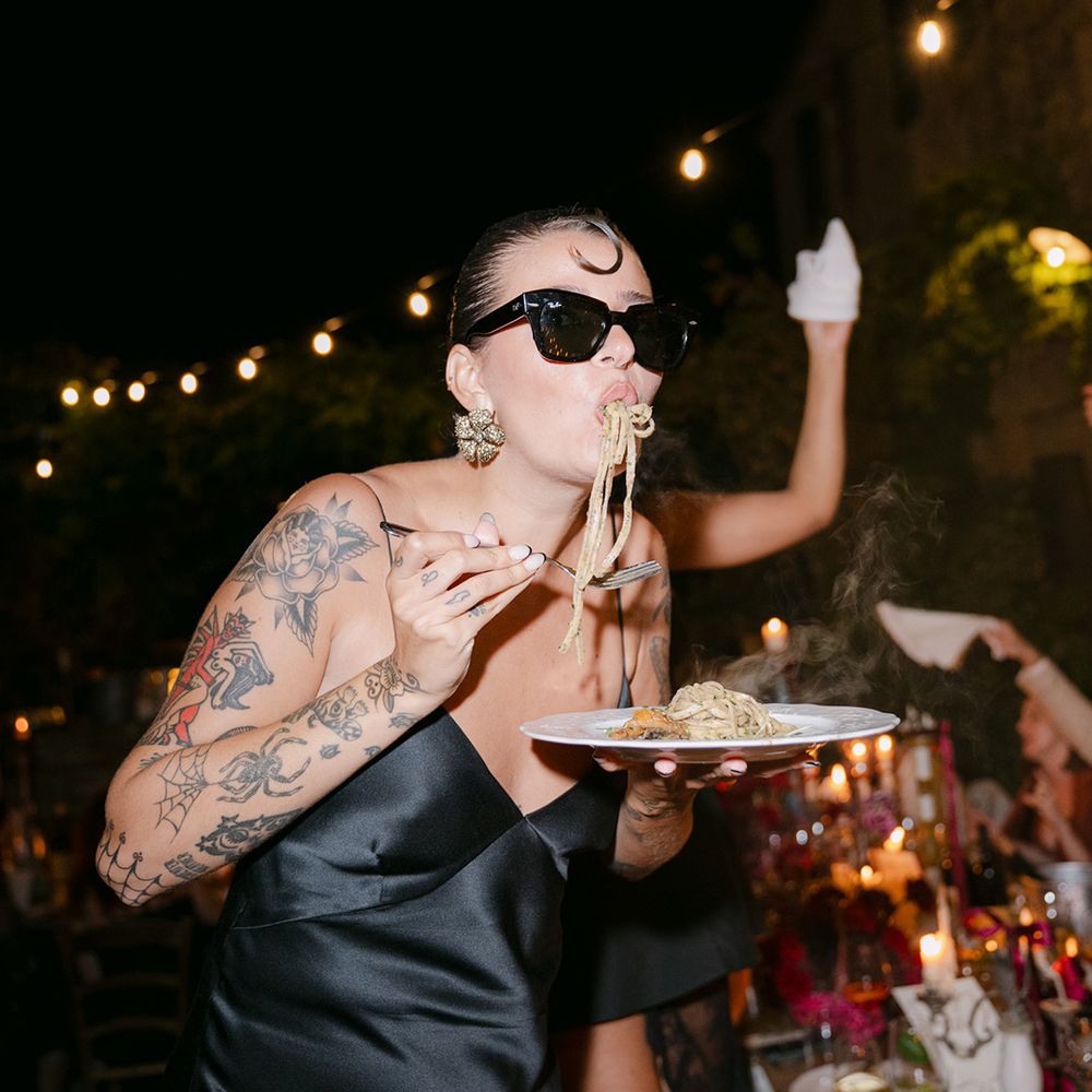 bridesmaid-eating-plate-of-pasta-with-sunglasses