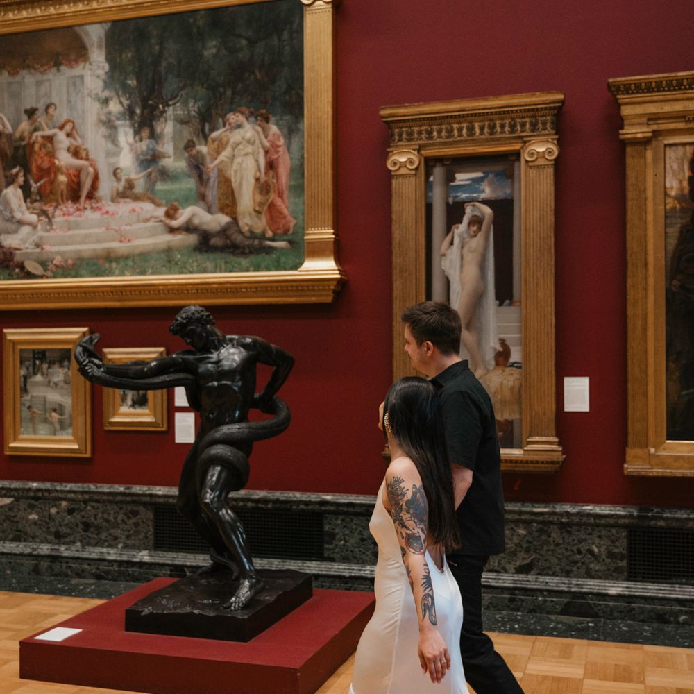 Couple walks around gallery for their engagement shoot