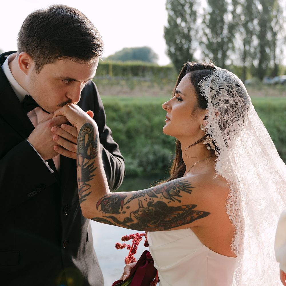 groom-kisses-brides-hand