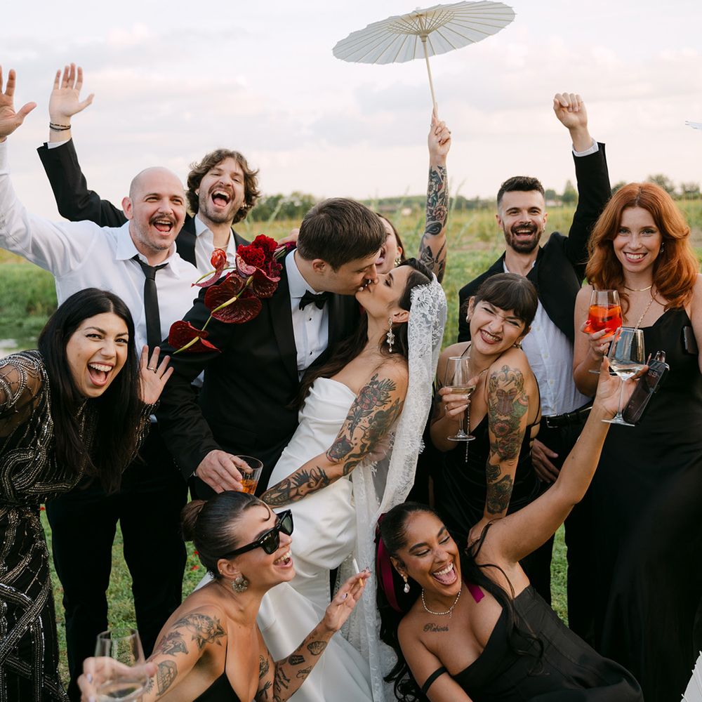 wedding-party-celebrates-as-couple-kisses