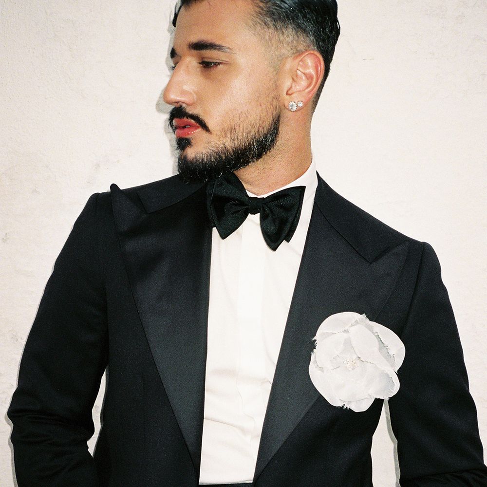 groom-in-black-tuxedo-with-white-flower-boutonniere