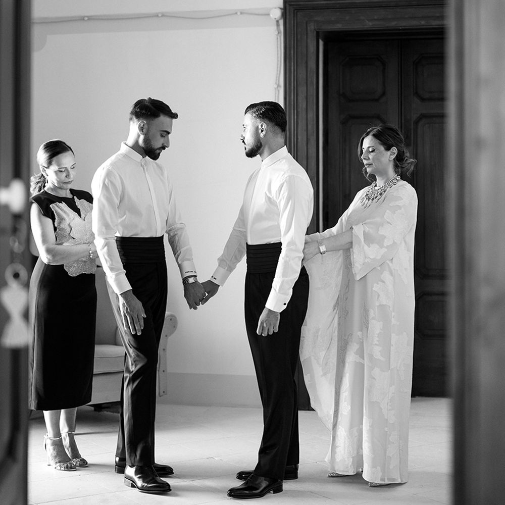 grooms-holding-hands-as-they-get-ready-for-their-wedding