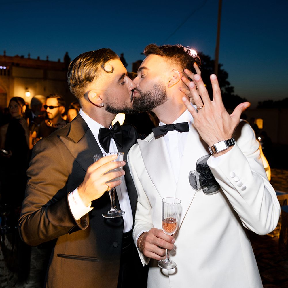 grooms-kiss-on-wedding-day-showing-off-new-wedding-rings