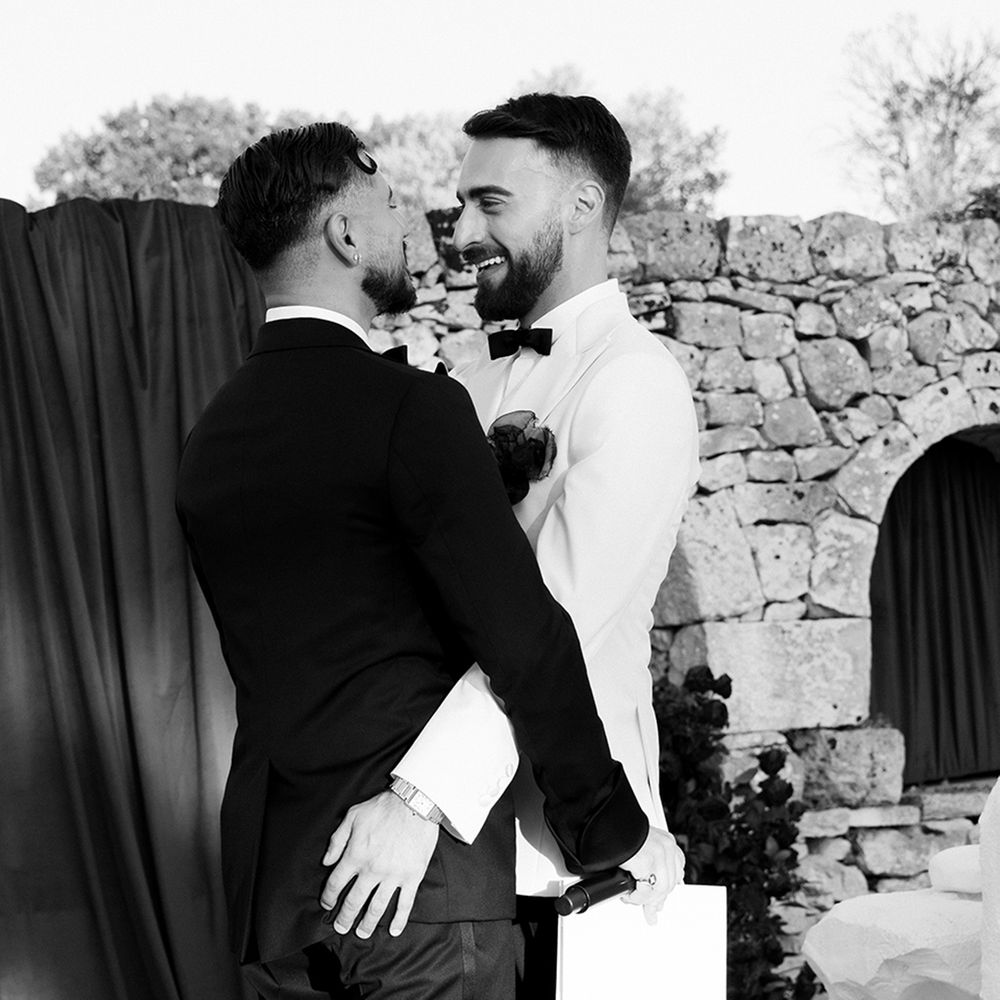 grooms-smiling-as-they-embrace-at-ceremony