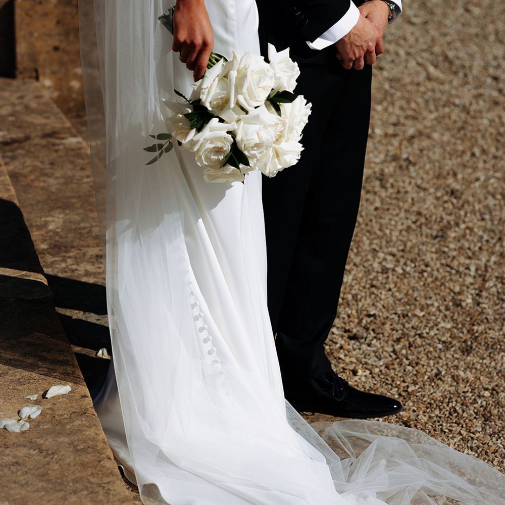 bride-carrying-white-rose-bouquet
