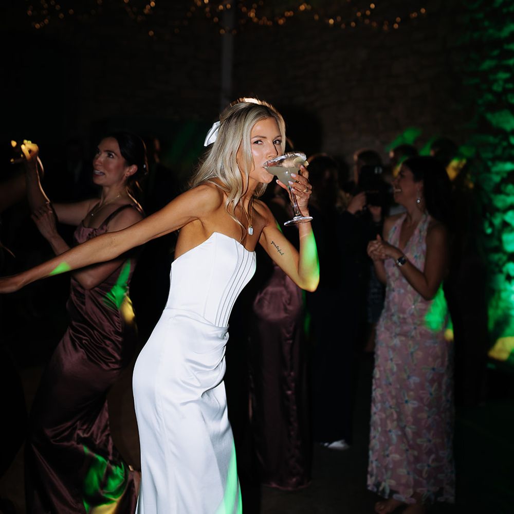 bride-drinking-signature-wedding-cocktail-at-reception