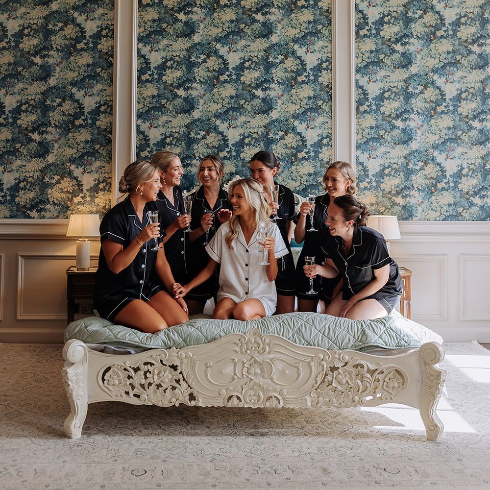 bridesmaids-and-bride-in-pjs-getting-ready-for-wedding