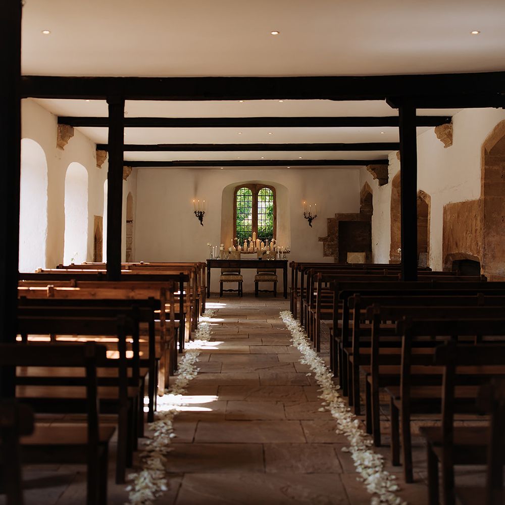brympton-house-wedding-ceremony-space-with-confetti-on-aisle.