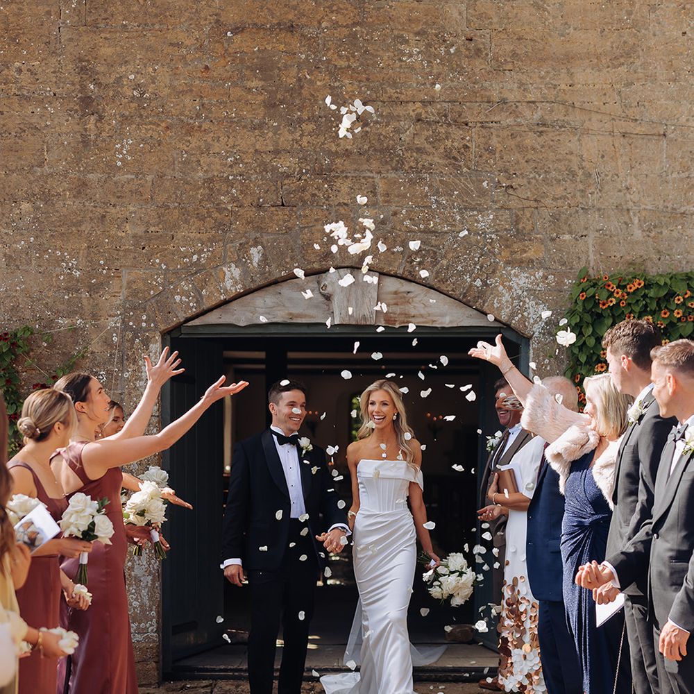 guests-throw-white-confetti-over-couple
