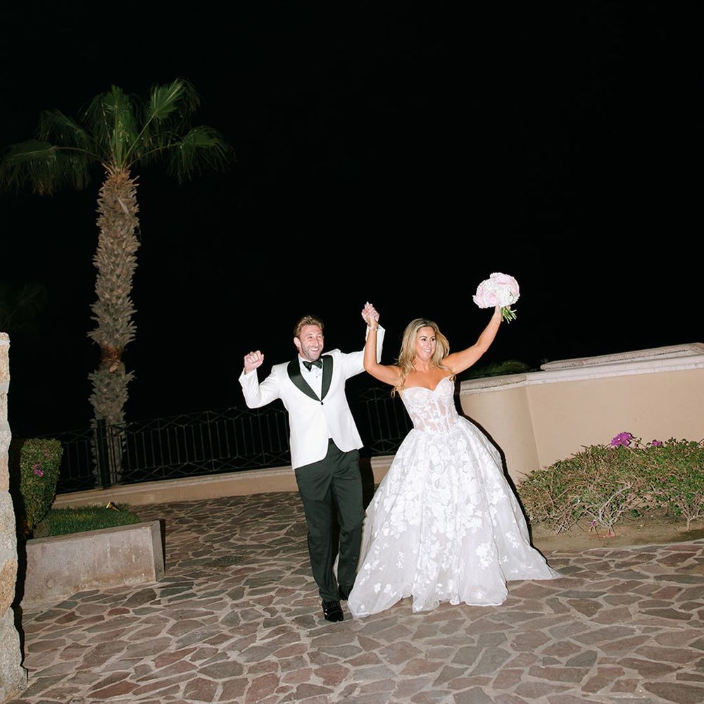 couple-walk-hand-in-hand-with-couple-in-black-tuxedo