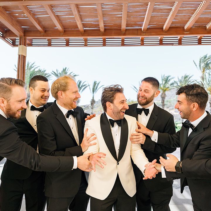 groomsmen-in-black-tie-hype-up-groom