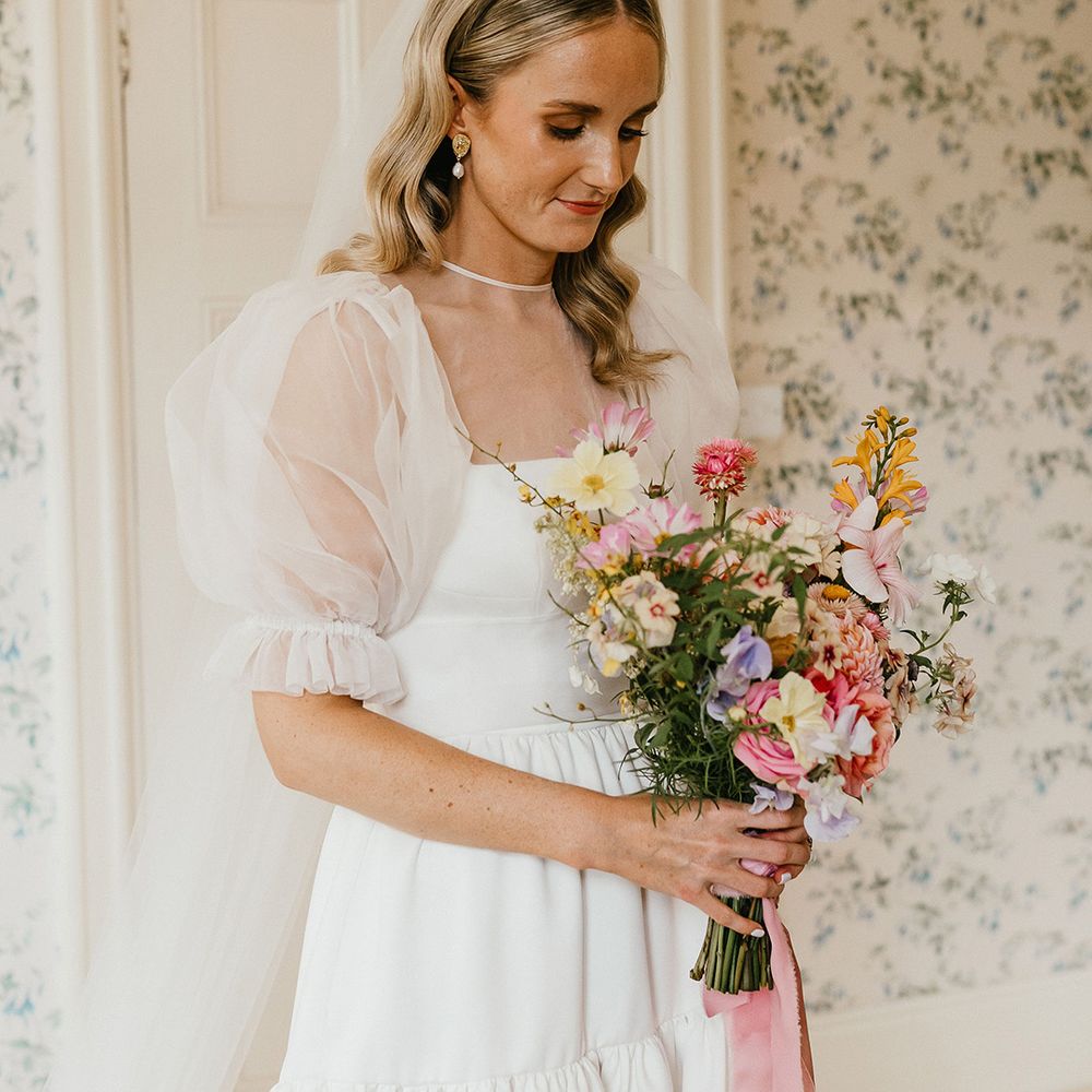 bride-carrying-pastel-wedding-bouquet-with-puff-sleeve-wedding-dress
