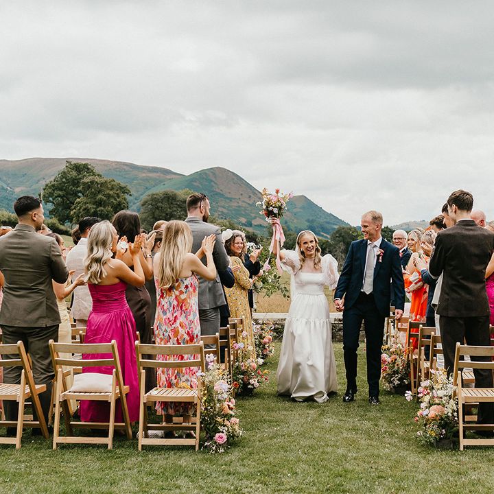couple-walks-back-down-the-aisle-at-outdoor-wedding
