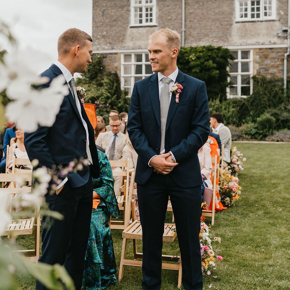 groom-and-best-man-stand-waiting-for-brides-to-walk-down-the-aisle