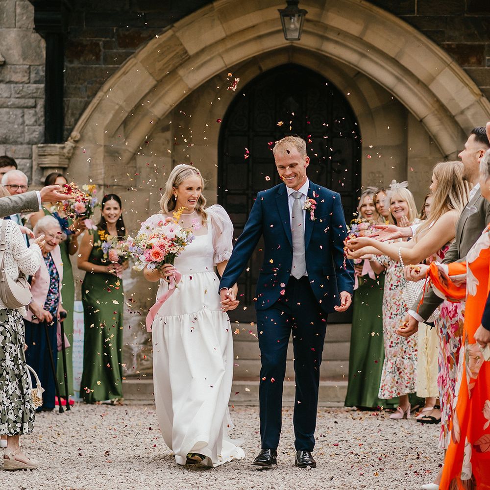 guests-throw-pink-confetti-over-couple