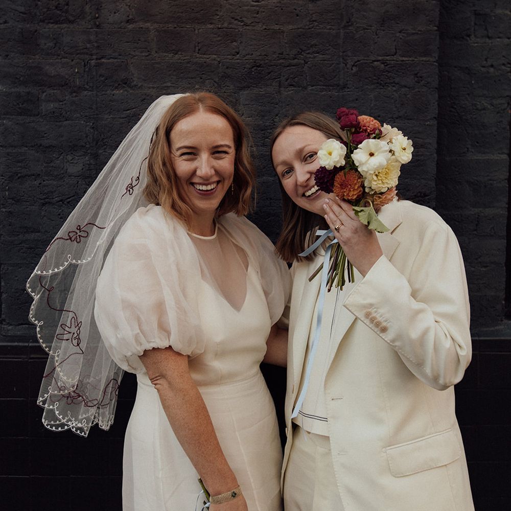 city-wedding-with-two-brides-posing-for-couple-portrait