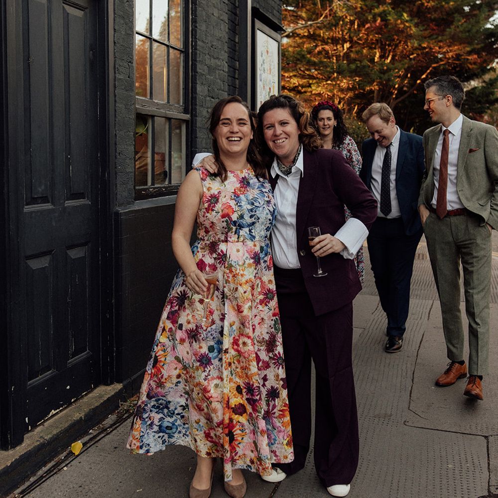 Couple posing for photos outside at pub wedding 