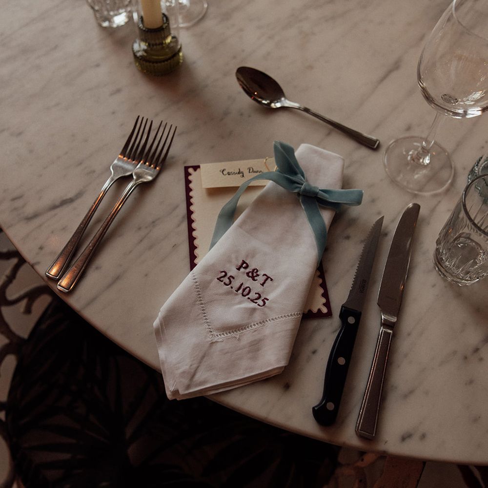 Simple wedding place setting with embroidered napkin