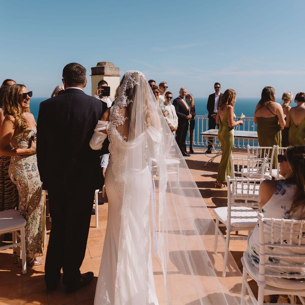 Bride and father walking down the aisle at sunny positano wedding