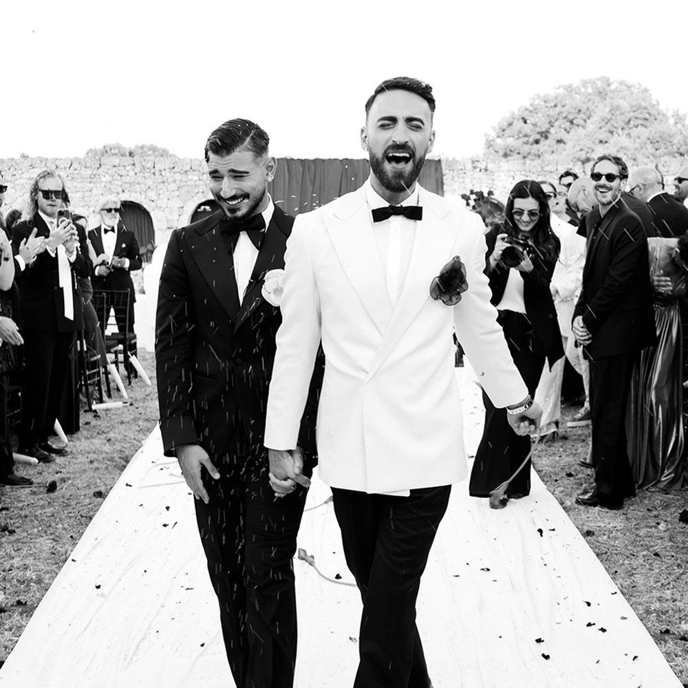 Grooms walking back down the aisle as married couple