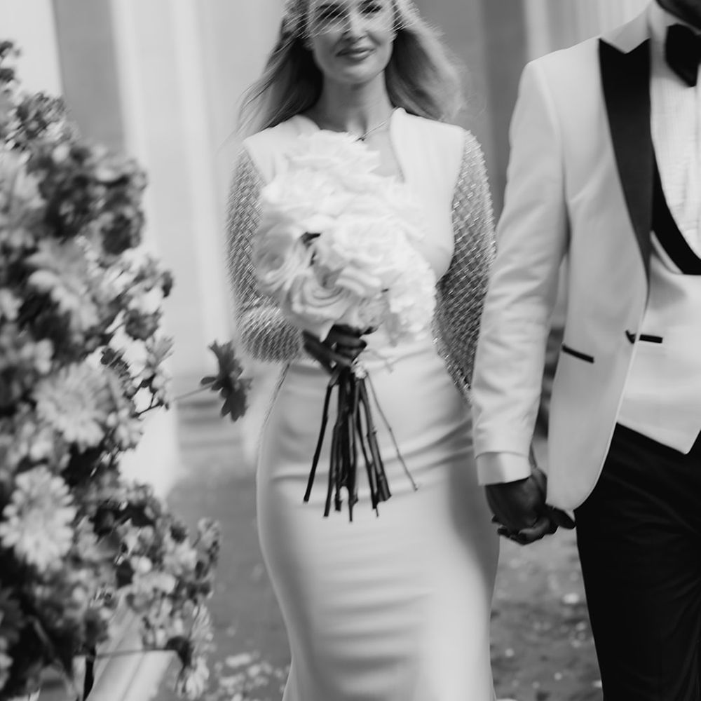 black-and-white-photo-of-bride-walking-with-groom