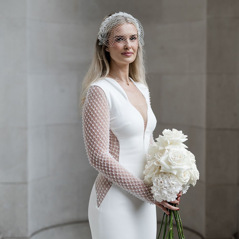 bride-in-sparkly-wedding-dress-with-white-rose-bouquet