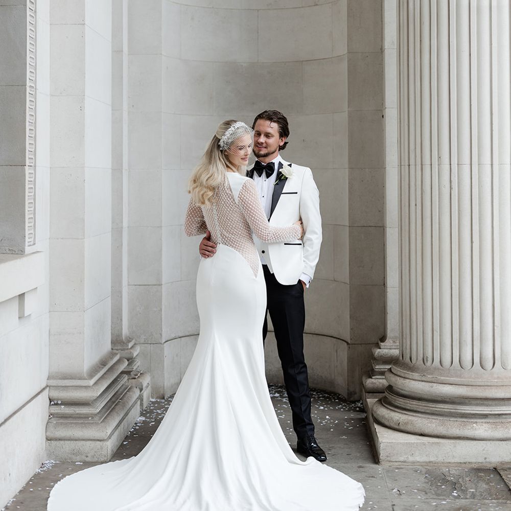 bride-with-long-train-with-groom-at-town-hall-london-wedding