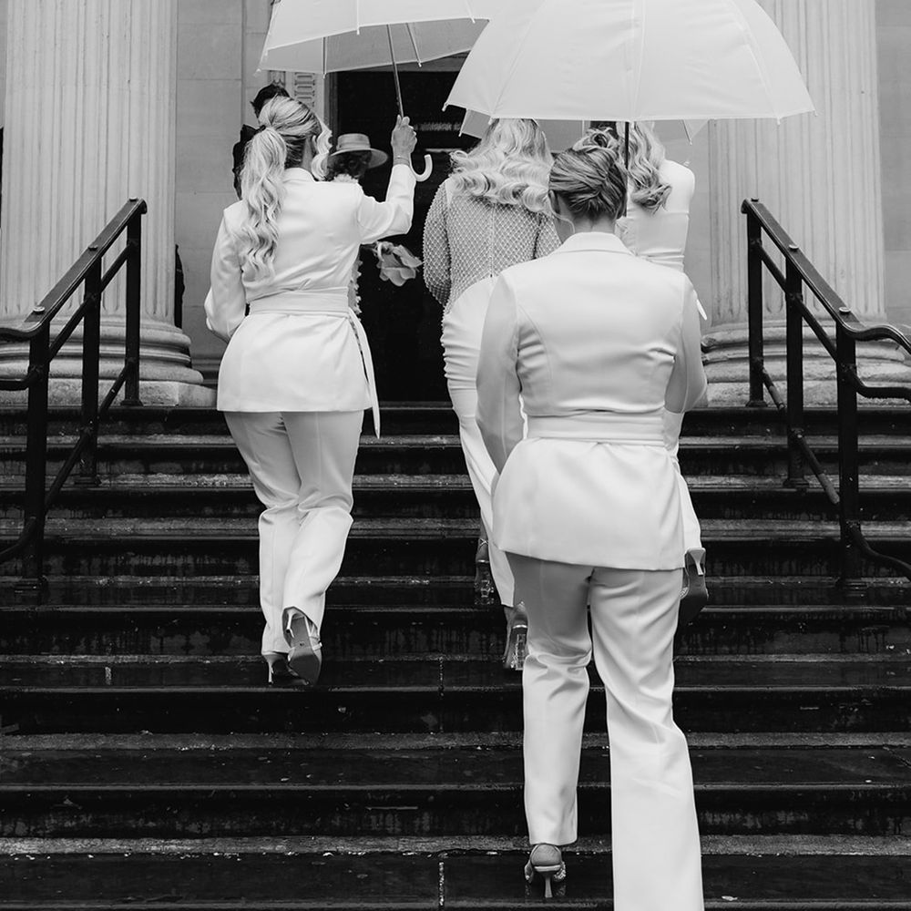 bridesmaids-in-matching-suits-and-umbrella