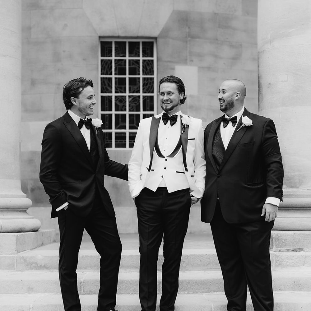 groom-and-groomsmen-in-black-tuxedos