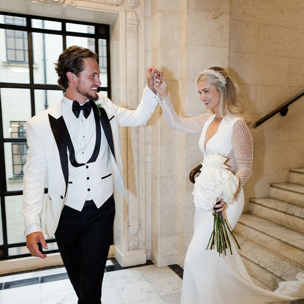 groom-in-black-and-white-wedding-tuxedo-with-bride-in-sparkly-long-sleeve-wedding-dress