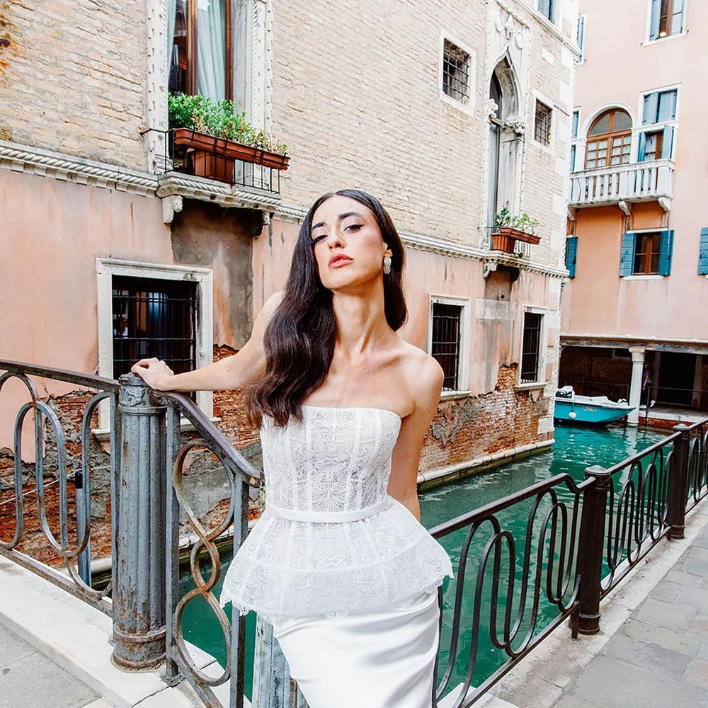 Bride wearing lace peplum corset wedding dress