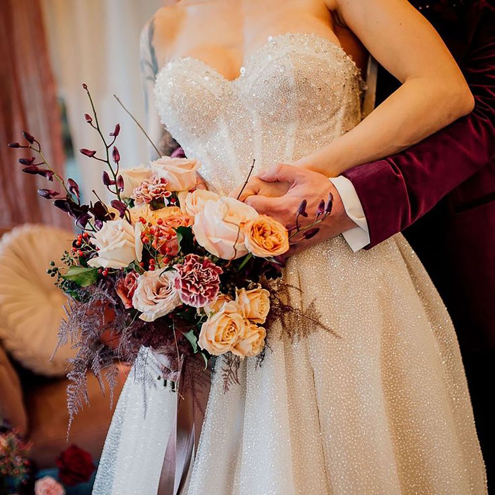 Bride wearing sparkly corset wedding dress with sweetheart neckline