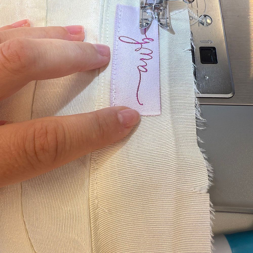 Abigail Westrup Bridal label being sewn in 
