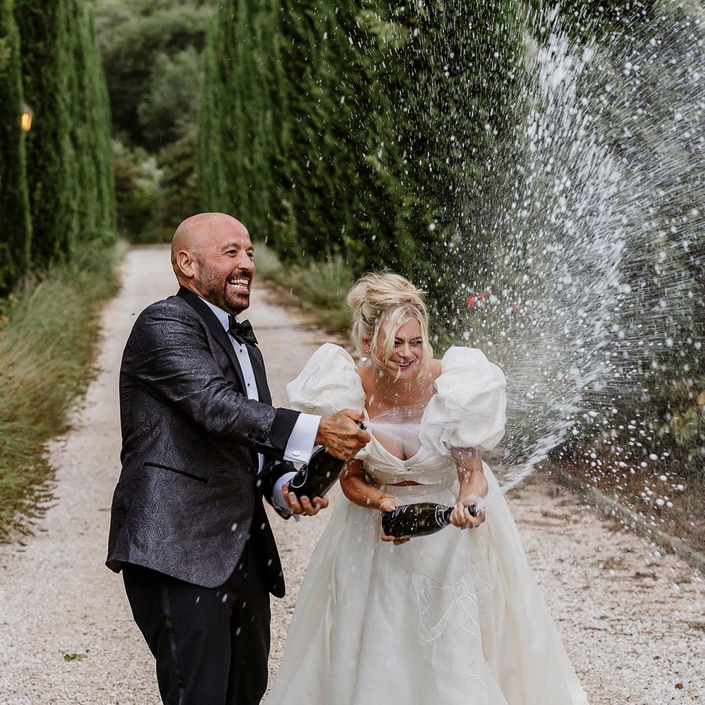 bride-and-groom-spray-champagne-in-celebration