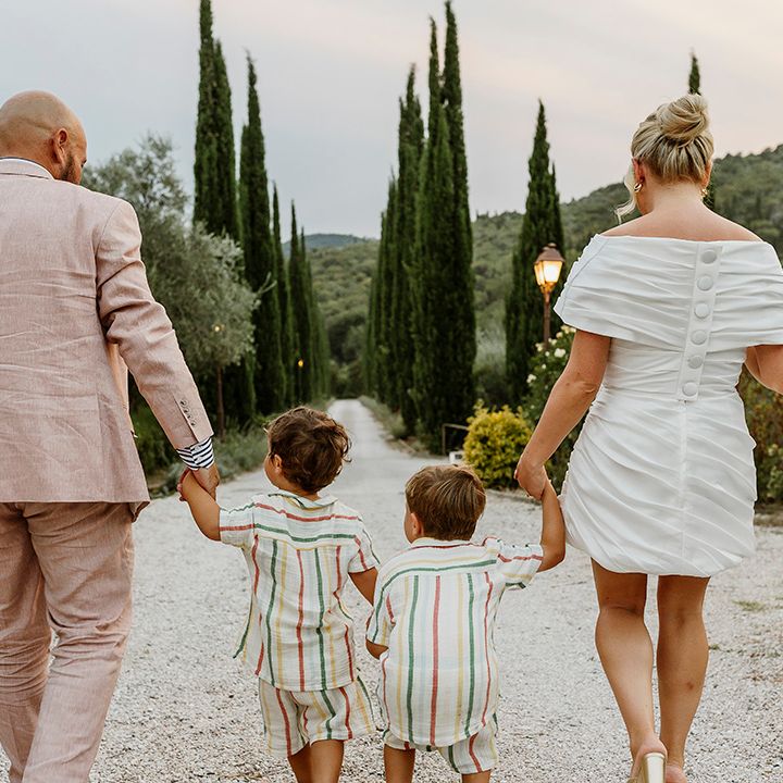 bride-and-groom-walking-with-their-sons-at-tuscany-wedding