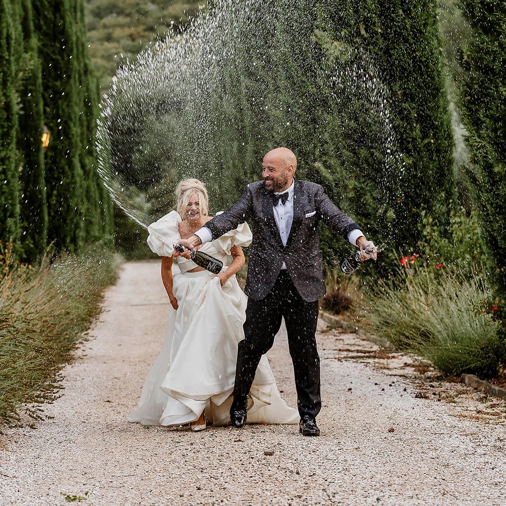 groom-sprays-two-bottles-of-champagne.