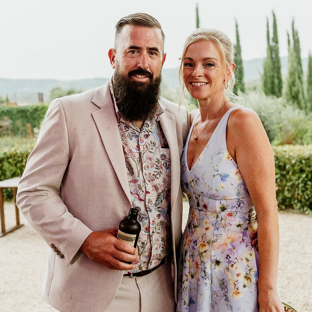 wedding-guests-in-pastel-floral-dress-and-cream-suit