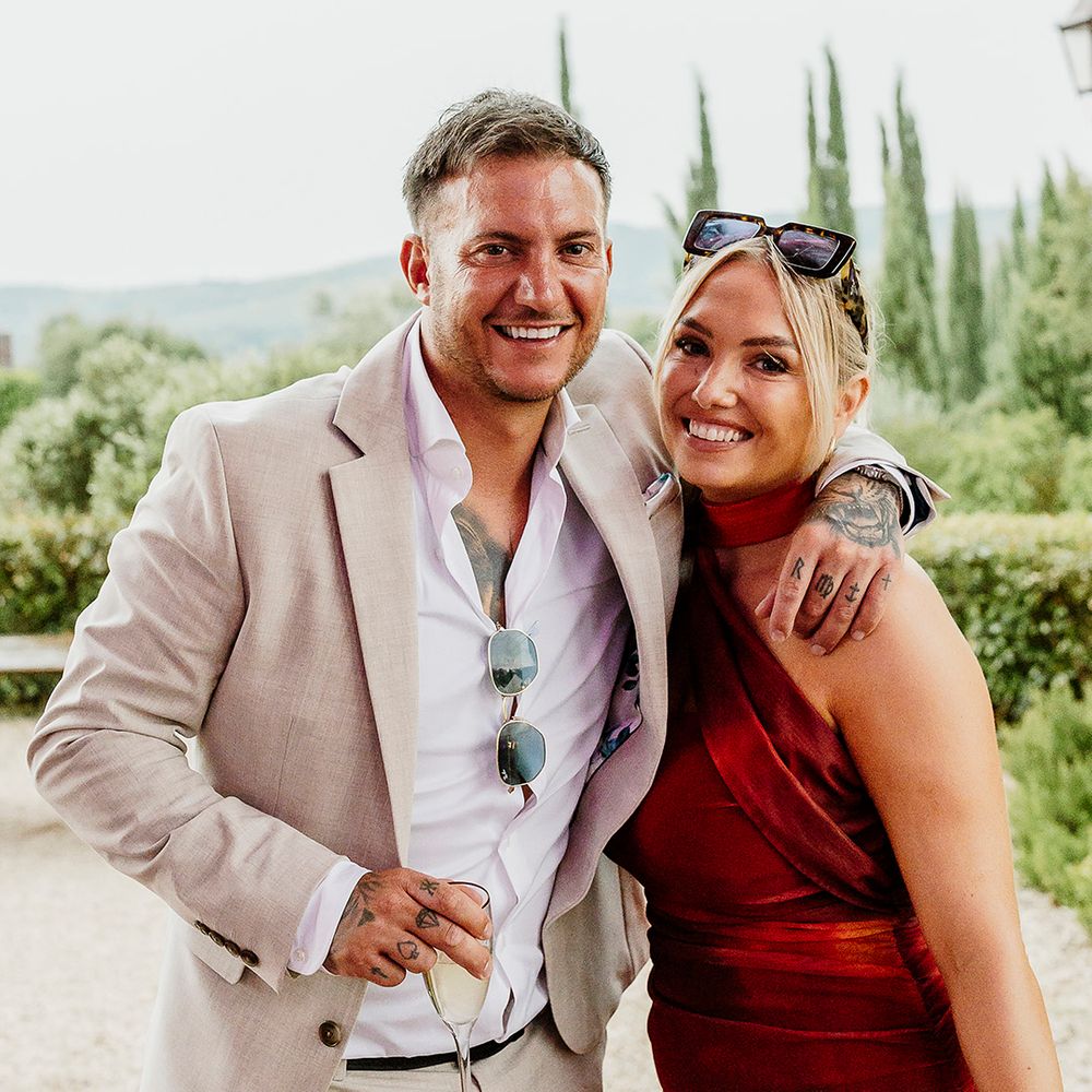 wedding-guests-in-red-dress-and-cream-suit