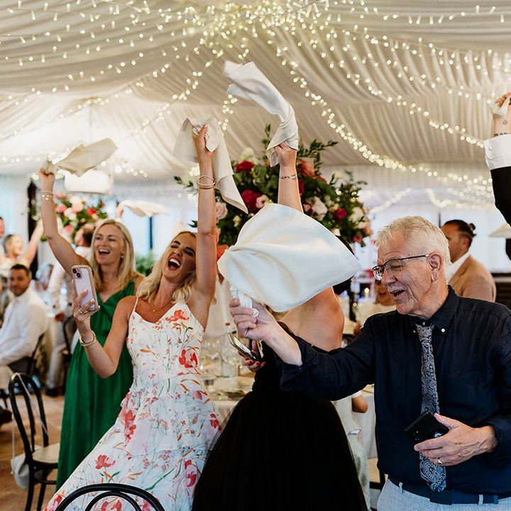 wedding-guests-wave-napkins
