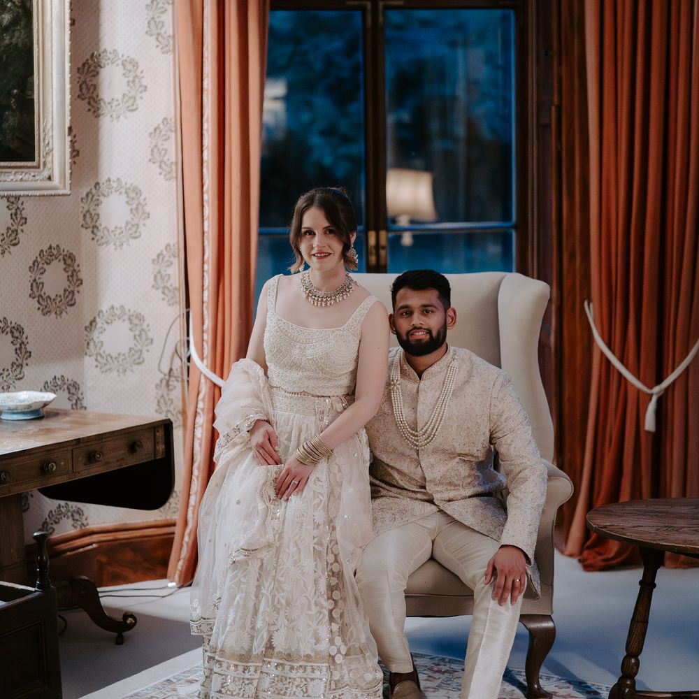 Couple seated on armchair together for library wedding