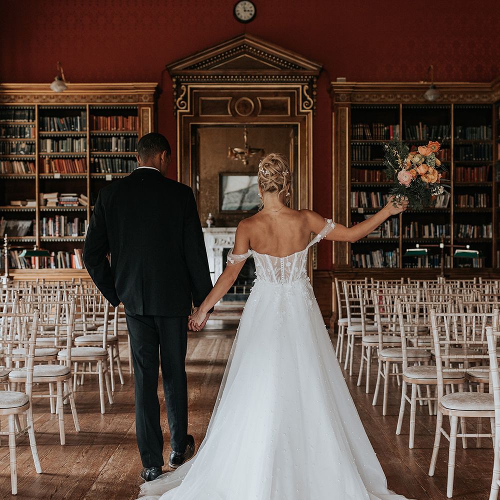 Westonbirt House Library Wedding as couple walks down the aisle