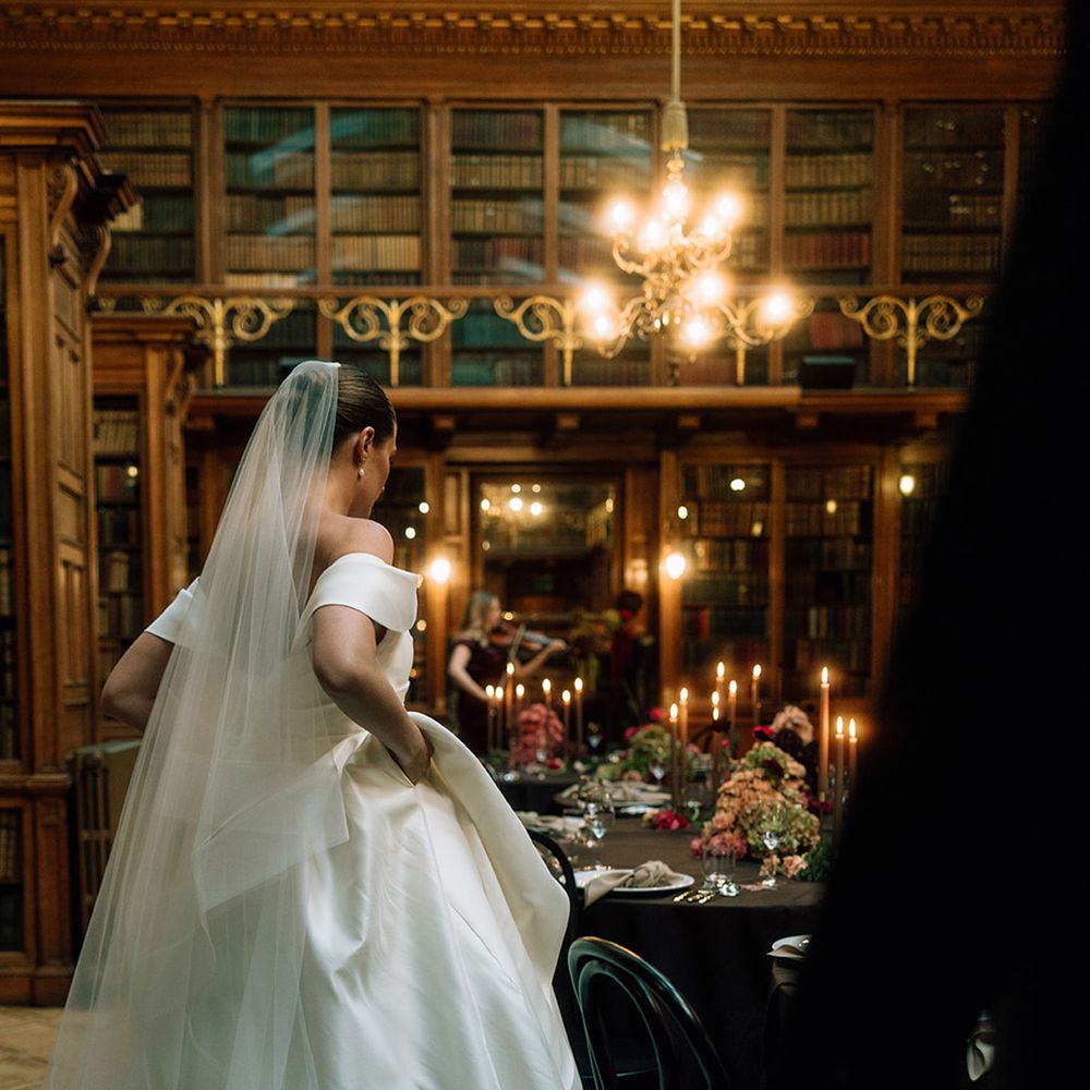 Bride in off the shoulder wedding dress at library wedding