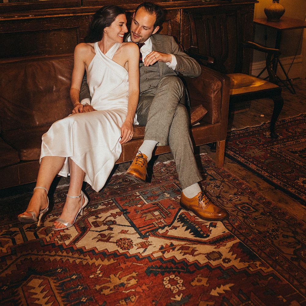 Flash photo of bride and groom seated together on wedding day