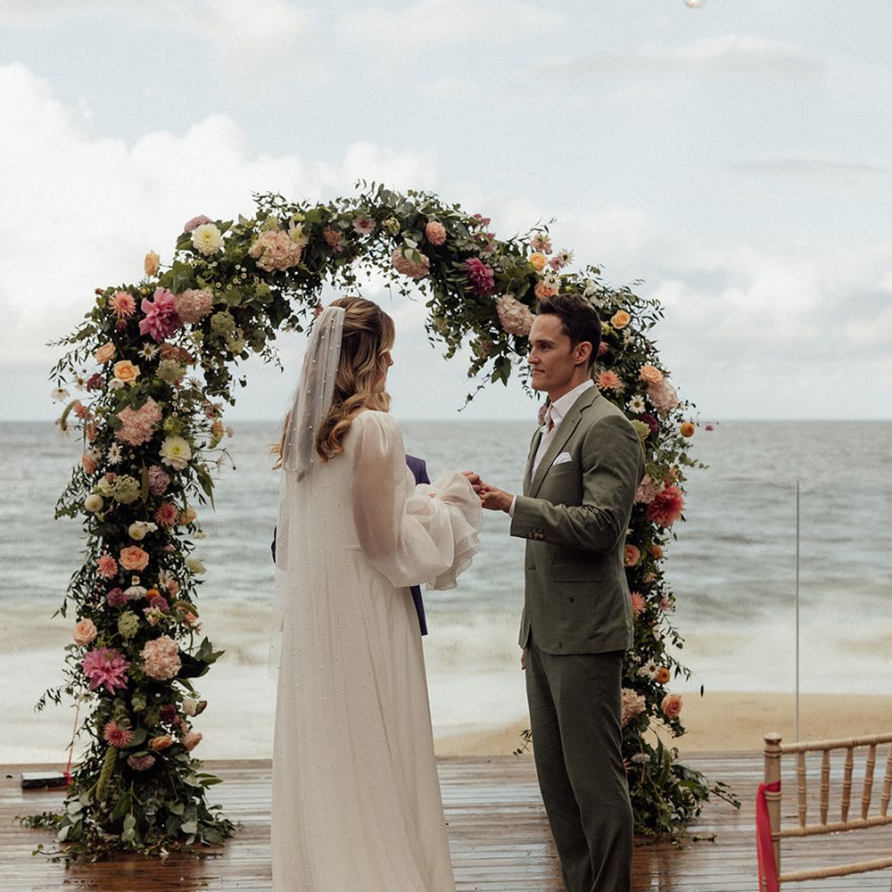 couple-outdoor-ceremony-under-arch-at-coastal-wedding