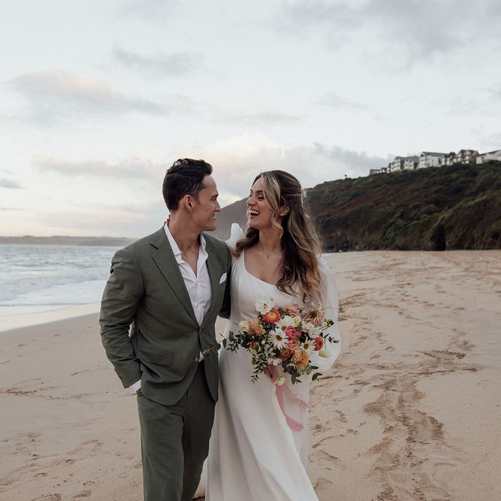 couple-walks-along-beach-for-relaxed-boho-coastal-wedding