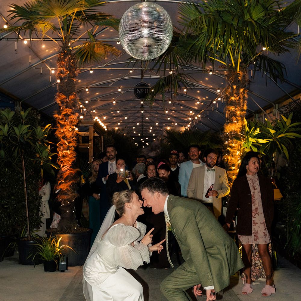 bride-and-groom-dancing-at-wedding-reception-with-disco-ball