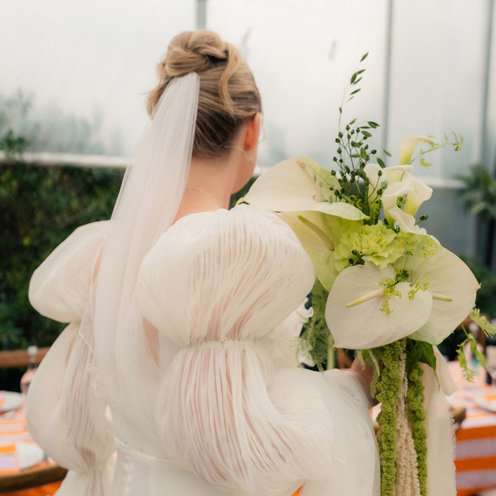bride-in-puff-sleeve-story-of-my-dress-wedding-dress-carrying-white-bouquet
