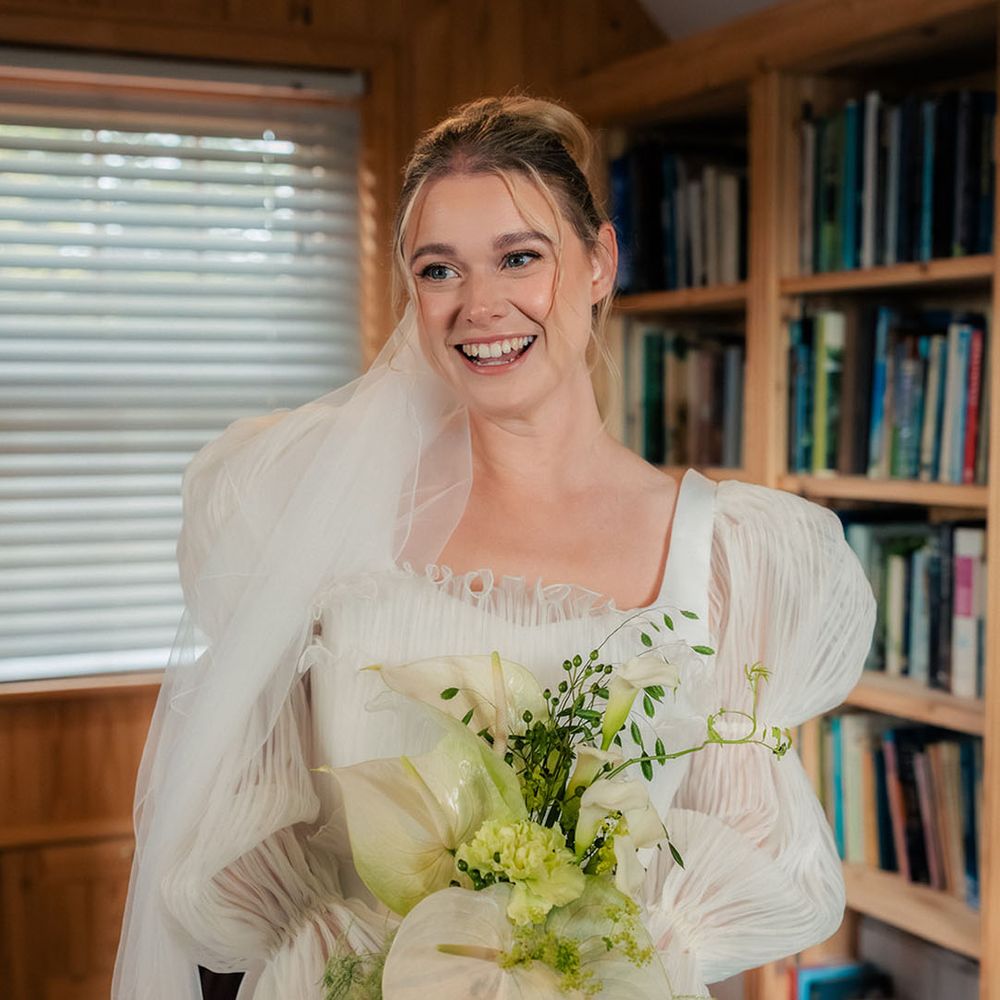 bride-in-story-of-my-dress-puff-sleeve-wedding-dress-with-white-bouquet