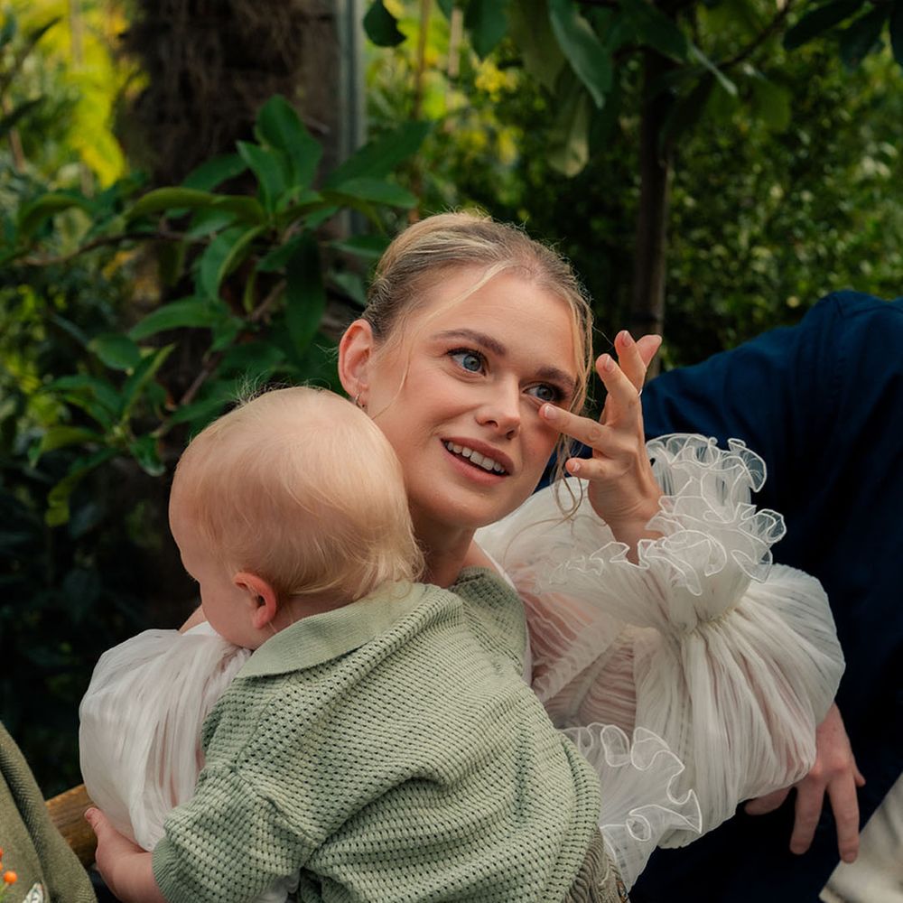 bride-wipes-tears-holding-baby